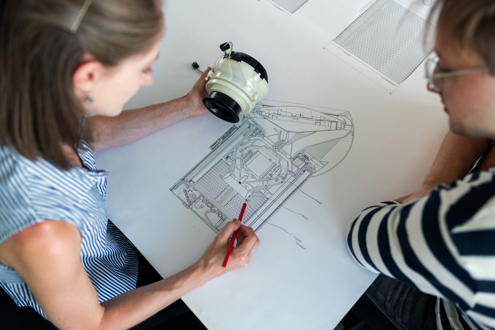 An engineering team reviewing an invention together