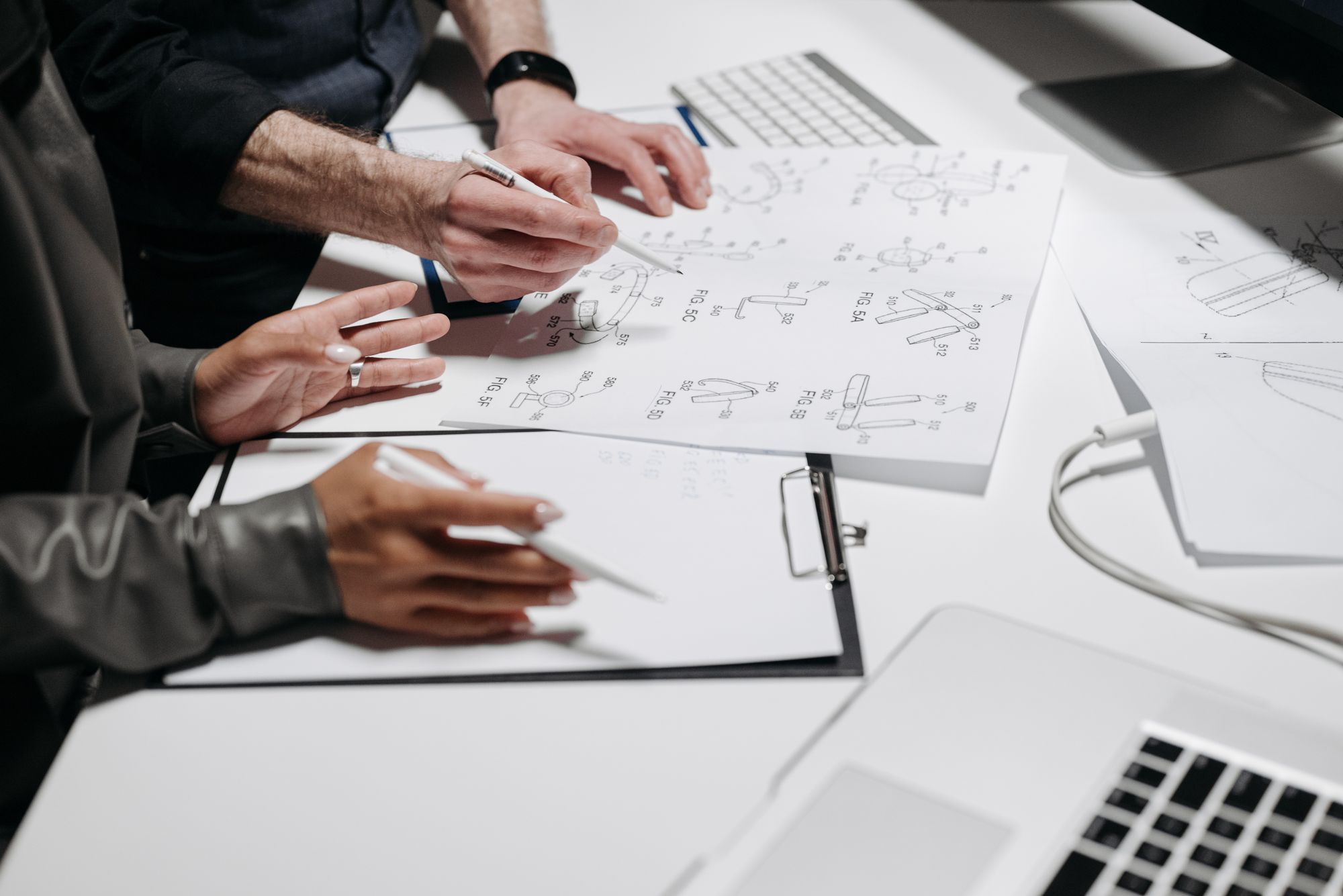 Patent diagrams and product documents being reviewed